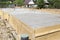 inspection well, trench and concrete slab of foundation with woo