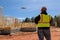 An inspector checks the quality of construction works on the construction site with the help of a drone