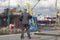 Inspector in coveralls and hardhat standing on harbor wharf.