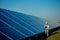 Inspector Engineer Woman Holding Digital Tablet Working in Solar Panels Power Farm, Photovoltaic Cell Park, Green Energy Concept