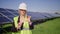 Inspector Engineer Woman Holding innovative Tablet Working in Solar Panels Power Farm, Photovoltaic Cell Park, Green