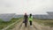 Inspector engineer woman and male engineer in protective helmet walks in photovoltaic power plant discussing maintenance