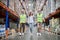 Inspector and storehouse workers conducting a racking system inspection