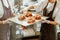 Inspertor checks croissants decorated with burnt cream with colleague in craft bakery