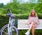 Inspiration strikes at any time. a young woman using a laptop on a bench while out for a cycle in the park.