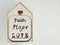 Inspirational concept - faith, hope, love text written on wooden frame background. Stock photo.