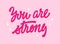 Inspirational, empowering trendy pink phrase lettering design - You are strong. Illustration of hand-drawn typography