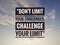 Inspirational motivating quote on nature background. Don't limit your challenges, challenge your limit.