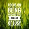 Inspirational motivating quote on nature background. Focus on being productive instead of busy