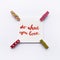 Inspirational quote Do what you love handwritten with watercolor in calligraphy style, miniature clothespins on a white background