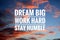 Inspirational quote - Dream big. Work hard. Stay humble. Sign and text message on dramatic colorful sky background.