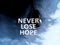 Inspirational quote - Never lose hope. With bulb lamp on blue and dark sky background. Hope concept