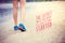 Inspirational quote poster on women`s legs running on beach