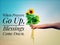 Inspirational quote - When prayers go up, blessings come down.  With hand holding bouquet of sunflowers against bright blue sky.