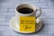 Inspirational quote text on yellow notepad on coffee cup - Start each day with a grateful heart. Motivational concept