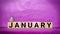 inspirational time concept - word January on wooden blocks in purple vintage background