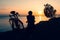 Inspirational view caucasian male cyclist sit by touring bicycle looking to scenic relaxing golden sunset background by sevan lake