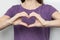 Inspire inclusion. Zoomers symbolize love. Faceless woman finger heart dressed purple t-shirt. Hand showing heart