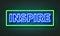 Inspire neon sign on brick wall background.