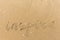 Inspire written on the beach sand