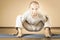 Inspired asian man doing exercise of yoga indoor