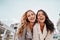 Inspired laughing ladies posing together on sky background. Outdoor photo of interested caucasian sisters enjoying good