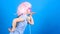 Inspired by music. Little kid listening music. Cute kid with headphones blue background. Small girl headphones pink wig