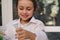 Inspired smart little school girl holds laboratory test tube and flask with chemicals and reagents in Chemistry class