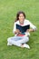 inspired teen girl read book sitting on grass. reading book. reader girl with book outdoor