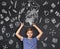 Inspired teenage boy holding globe with graduation hat above head