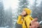 Inspired traveler girl enjoying snowy winter walk in forest, feeling good concept, follow me hand