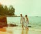 Instagram colorized vintage couple on beach portrait