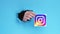 Instagram icon social media hand breakthrough hole