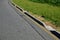Installation of concrete curbs with gaps that let water into the park into the ditch, where it seeps into the grass and does not d