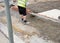 Installation of edging pin kerb on semi-dry concrete during footpath construction on new housing development construction site