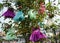 Installation with hanging children`s dresses on the tree
