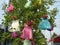 Installation with hanging children`s dresses on the tree