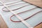 Installation of modern underfloor trace heating system indoors, closeup