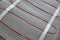 Installation of modern underfloor trace heating system indoors, closeup