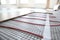 Installation of modern underfloor trace heating system indoors, closeup