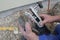 Installation of an outdoor tap Installer closes water pipe with crimping pliers on the construction site