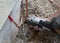 Installation of an outdoor tap Installer closes water pipe with crimping pliers on the construction site