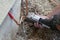 Installation of an outdoor tap Installer closes water pipe with crimping pliers on the construction site