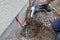 Installation of an outdoor tap Installer closes water pipe with crimping pliers on the construction site