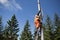 Installation road sign on pole. Road worker sets sign.