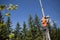 Installation road sign on pole. Road worker sets sign.