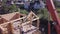 Installation of roof rafters wooden house. Clip. Top view of construction of wooden house with workers and crane on