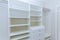 Installation shelves with interior of white plastic cabinet or clothing with many empty