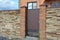 Installation of Stone Fence with Metal Door, Gate