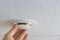 Installation and testing of smoke detector on the ceiling in the apartment or office. Human hand tests the sensor. Copy space